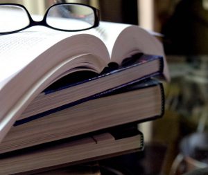 Pile of textbooks and glasses