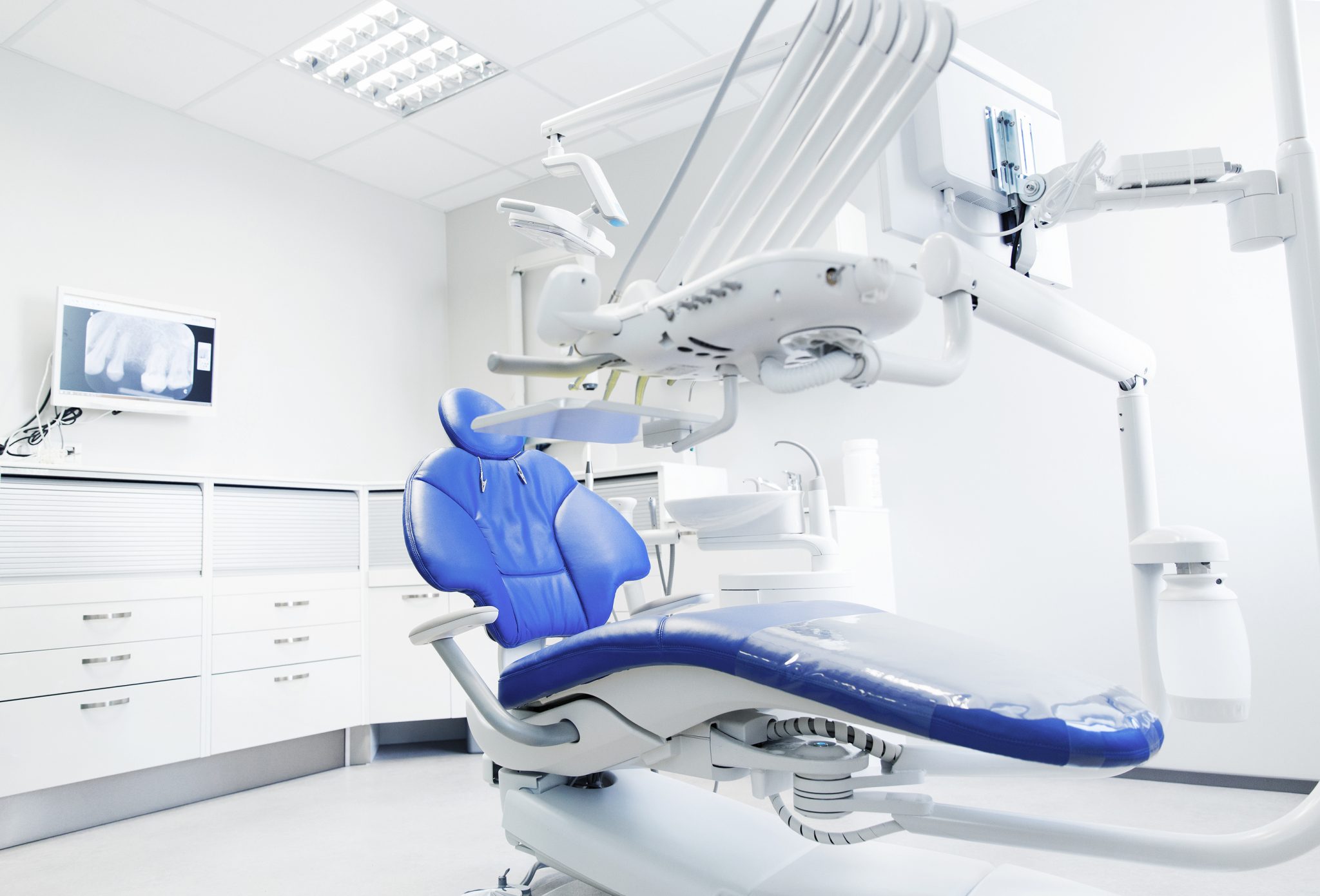 modern dentist office with blue chair and latest equipment